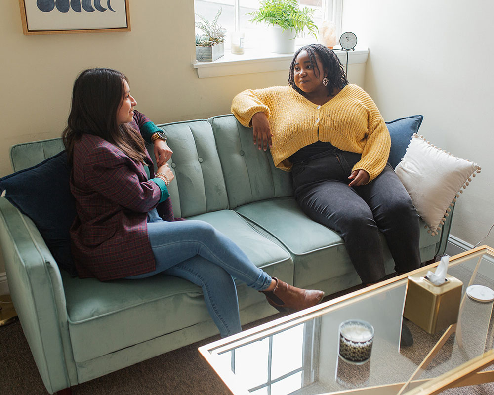 women sitting on couch during ACT therapy session