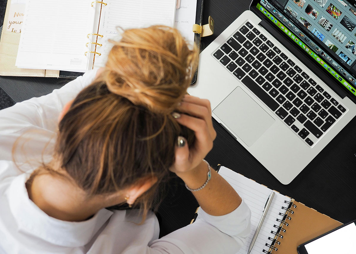 woman working on laptop but struggling with OCD