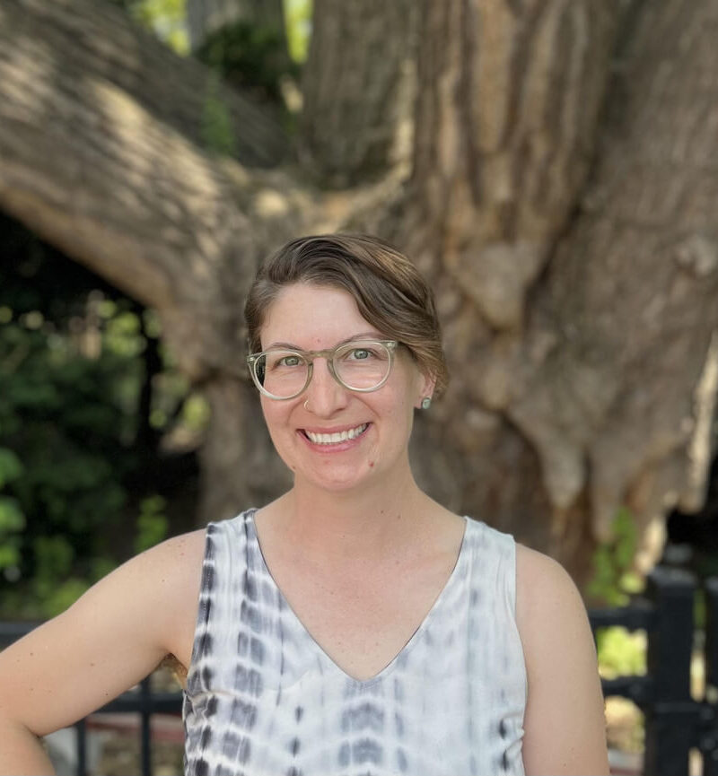 Portrait of Ashley Gyuriska, MA, NCC standing in front of tree