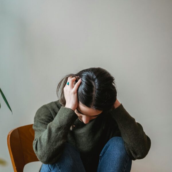 woman with head in hands experiencing link between hormones and anxiety