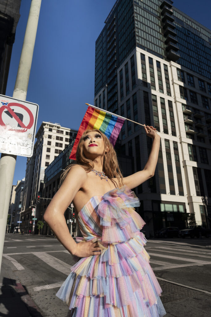 Member of the LGBTQ community flying pride flag in Philadelphia