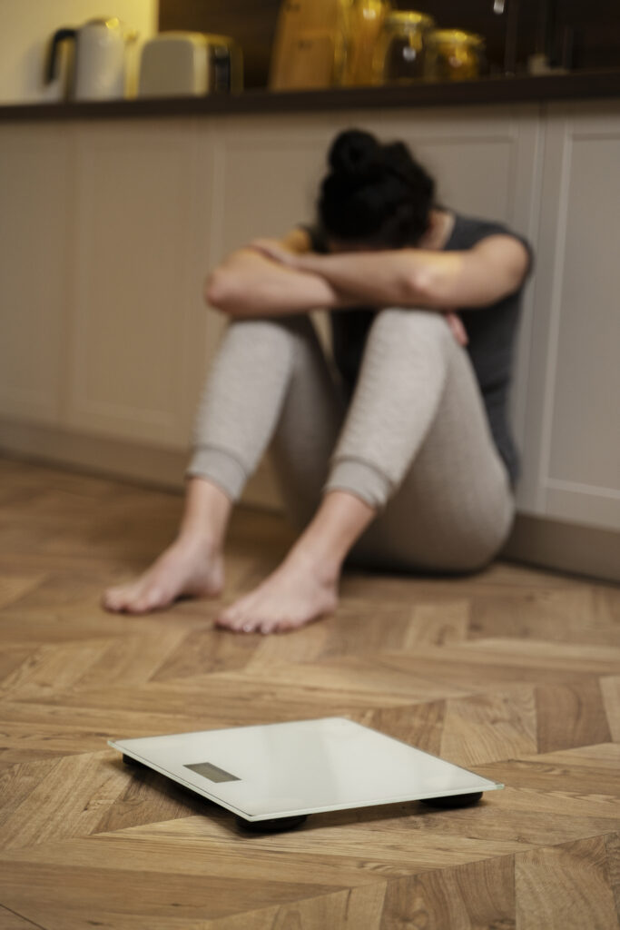 woman on floor trying to get into bulimia recovery 