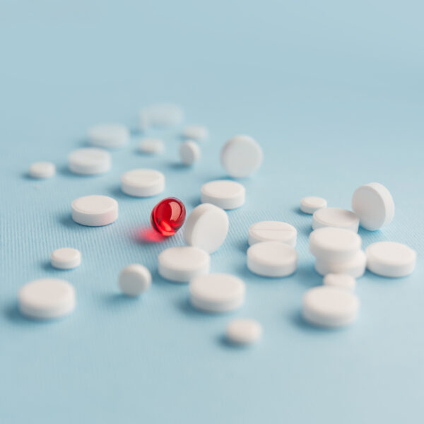 white ADHD pills on a blue background