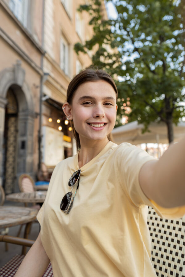 Selfie of woman in the sun on a patio
