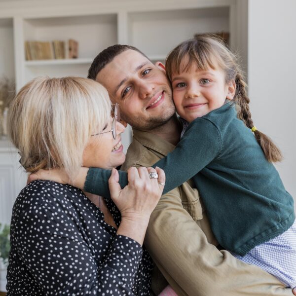 portrait of man, woman, and girl hugging