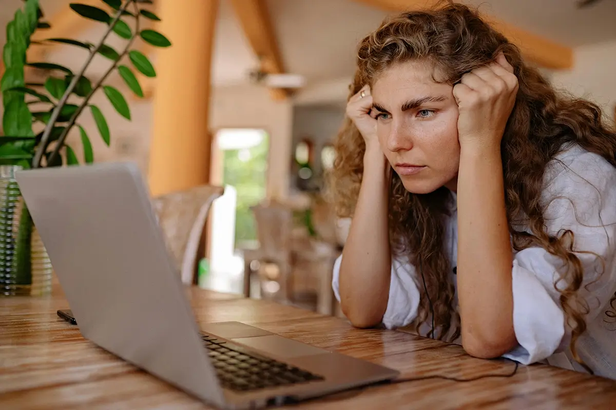 woman with adhd staring at computer trying to concentrate