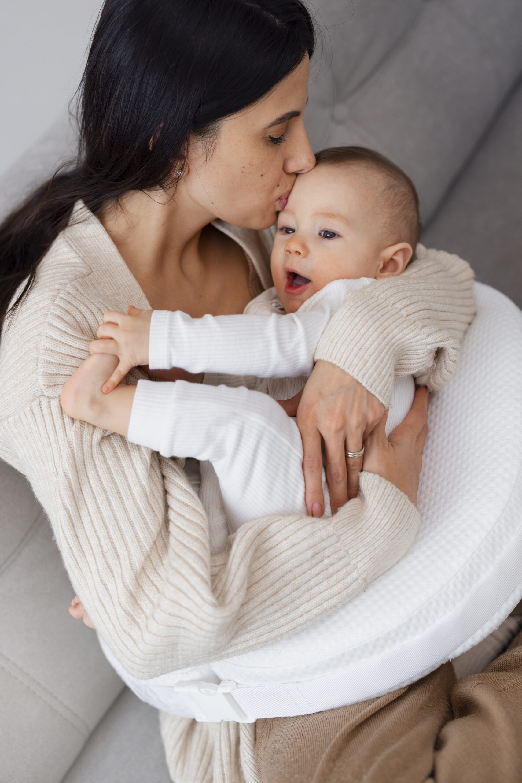 Mother holding her baby struggling with harm OCD and intrusive thoughts postpartum