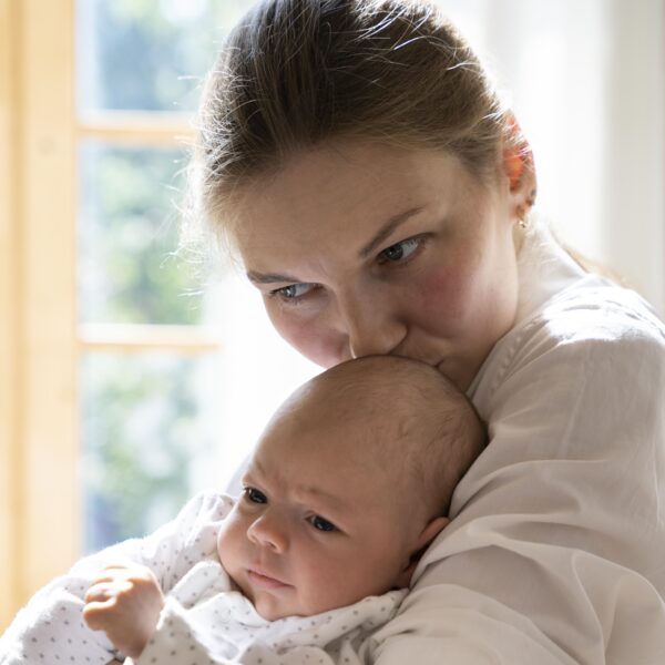 postpartum mother holding her baby