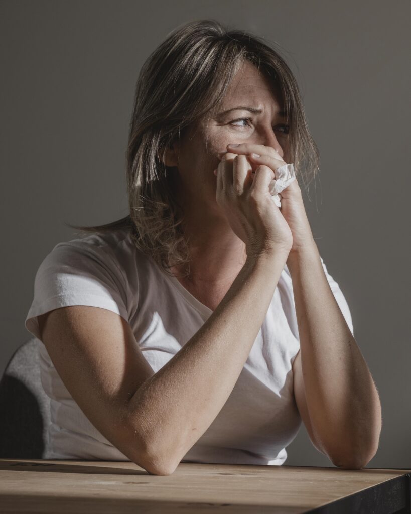 woman crying with a tissue experiencing emotional abuse