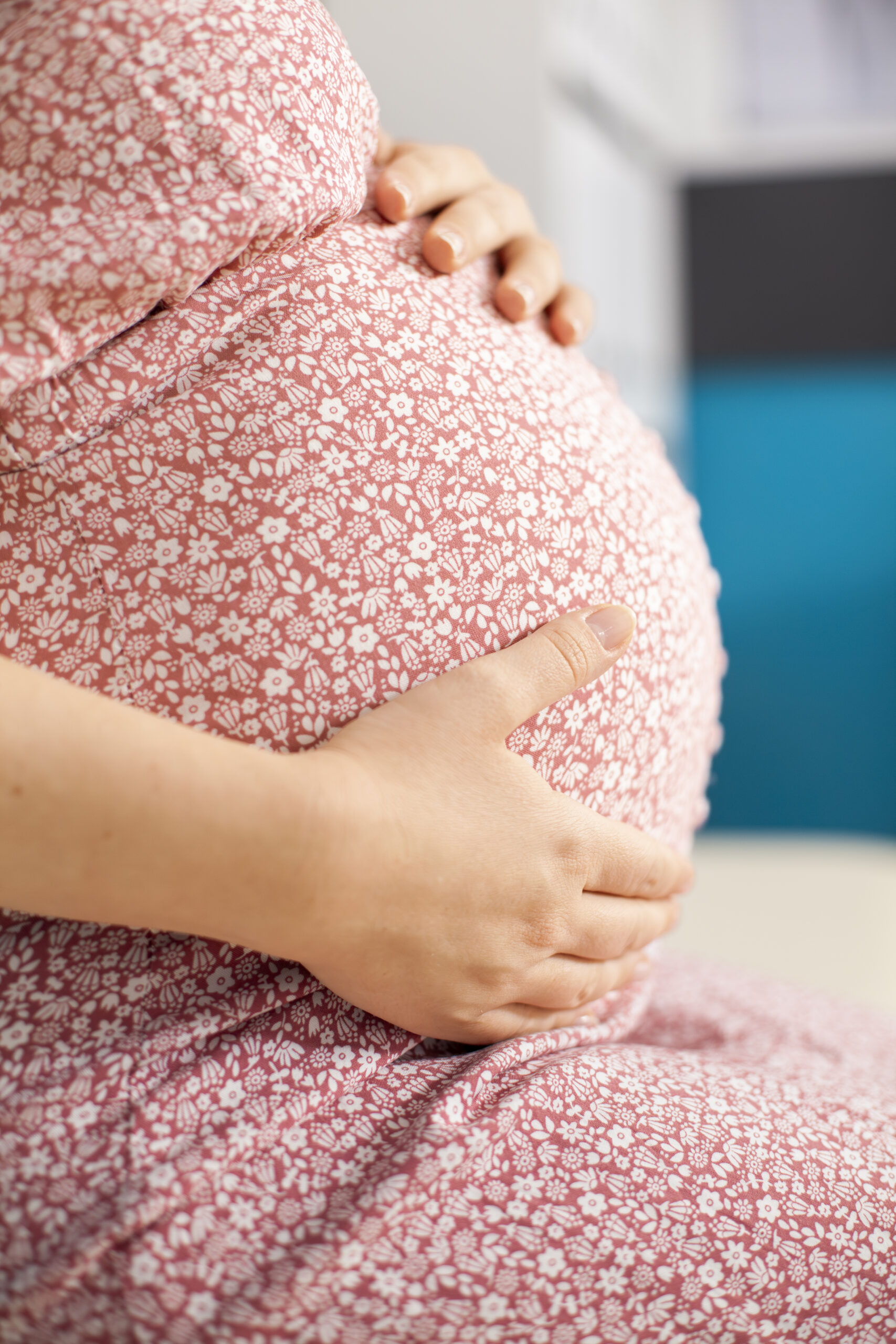 Woman holding her pregnant belly getting tokophobia therapy for fear of childbirth