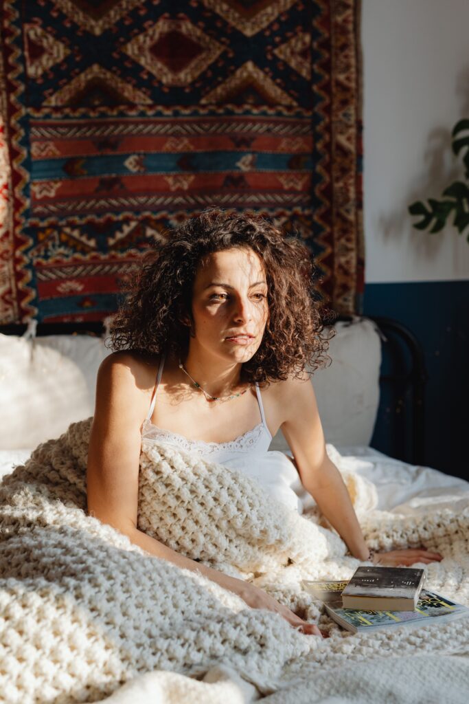 woman in bed looking out of it struggling with perimenopause anxiety