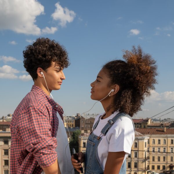 Photo of young couple listening to music for article about attachment theory