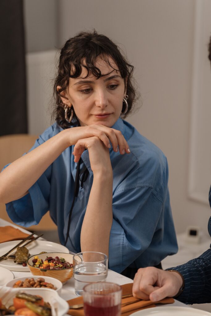 woman with atypical anorexia struggling to eat dinner
